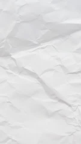 White crumpled and wrinkled paper texture background, stop motion vertical footage 4K