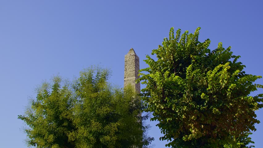 Ancient Walled Obelisk Partially Hidden by Trees in Sultanahmet Square, Istanbul