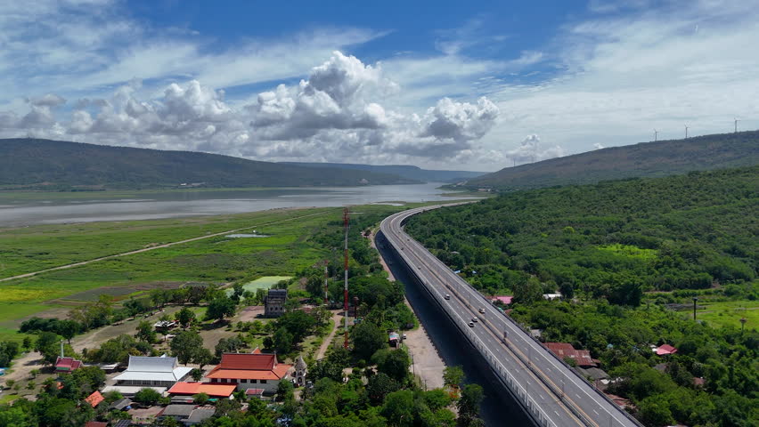Drone shot The M6 motorway Nakhon Ratchasima Province - Bang Pa-in Lam Ta Khong River and Mountain Drone shot of scenic landscape rural place traffic. Motorway Korat Thailand