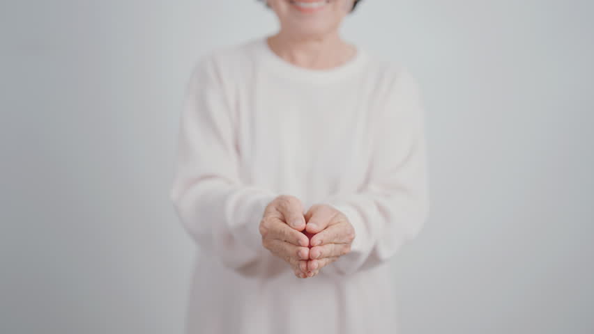 Elderly woman with pink Ribbon for Pink October Breast Cancer Awareness month, May Women Health, February World cancer day, support people life and illness. National cancer survivors month