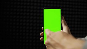 Smartphone with Green Mock-up Screen Doing Swiping Scrolling Gestures Point of View Shot Internet Social Networks Browsing - Powered by Shutterstock - Get 15% off with code: PIKWIZARD15