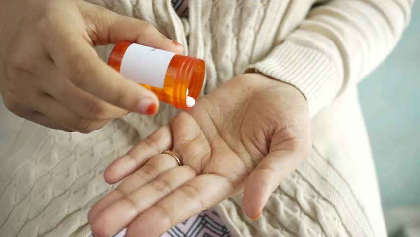 Drug over dose Concept Many Pills. Macro Of female Hand Holding Several Pill from medicines bottle Healthcare and Medicine