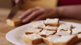 Cheese is spread on toasted bread. Making cheese sandwiches. - Powered by Shutterstock - Get 15% off with code: PIKWIZARD15