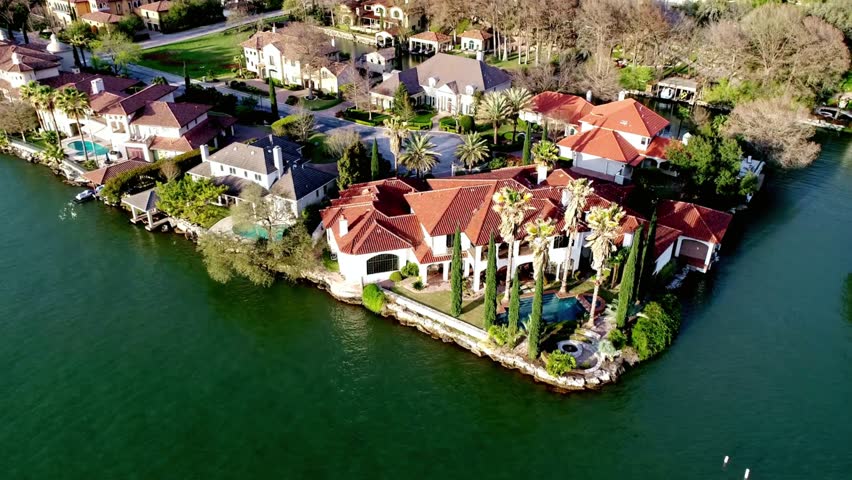 Aerial view of luxury waterfront homes on lake austin, texas on a sunny day