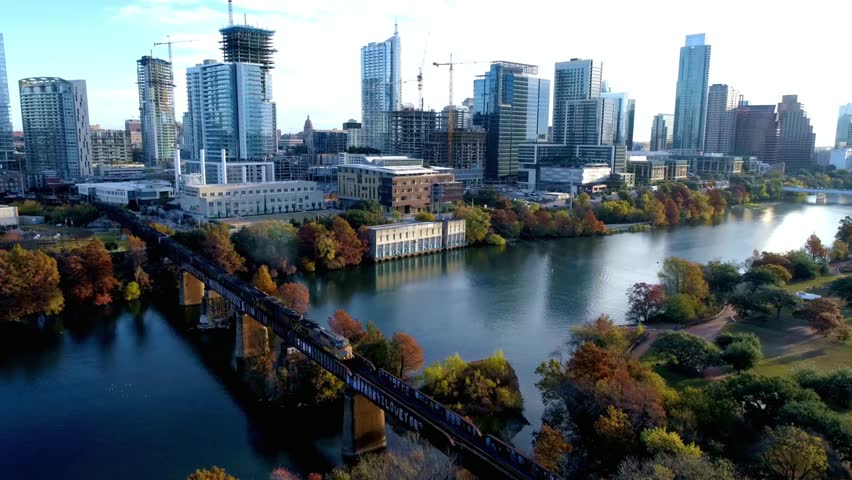 Aerial view of Austin Texas skyline with bridge over Colorado River in autumn
