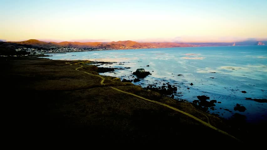 Coastal landscape with a path leading to the ocean at sunset in california