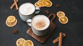 Two mugs with warm drinks and spices, cozy autumn beverage with dried oranges and cinnamon sticks - Powered by Shutterstock - Get 15% off with code: PIKWIZARD15