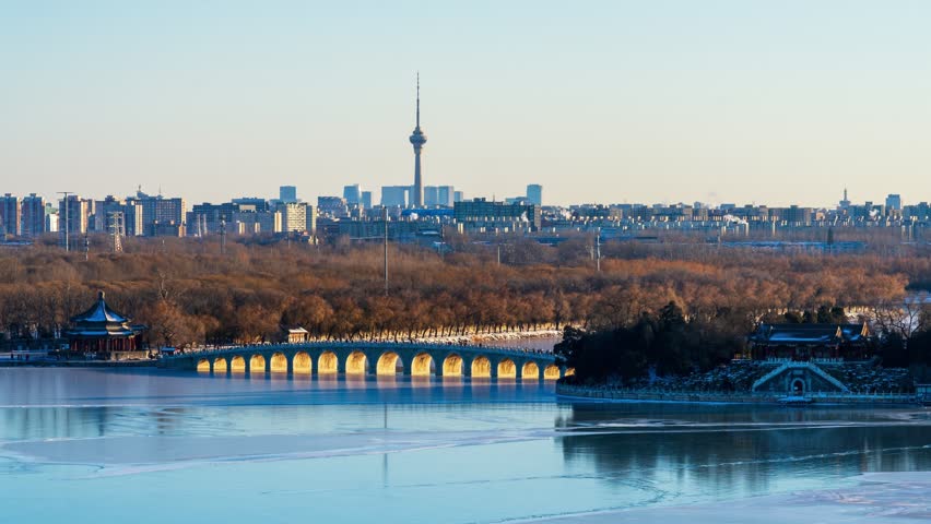 Beijing, China - 19th December 2023 - Overlooking Beijing Summer Palace Seventeen-Arch Bridge golden light illuminating the holes