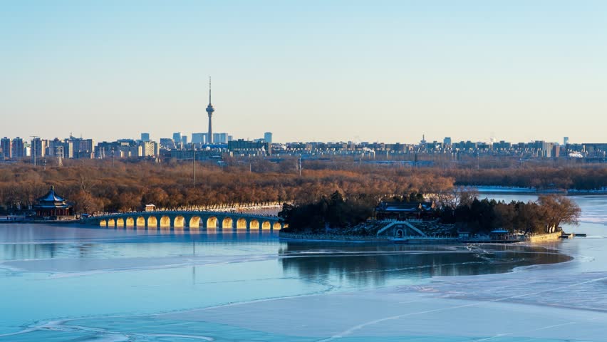 Beijing, China - 19th December 2023 - Overlooking Beijing Summer Palace Seventeen-Arch Bridge golden light illuminating the holes