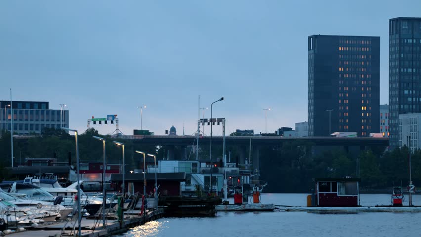 Stockholm, Sweden The elevated E4 highway or Essingeleden passes on an overpass above a marina in downtown in the early morning.  