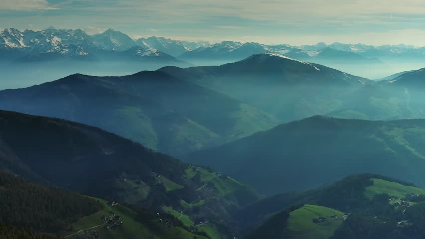 Aerial view of smoky mountains under mist in the morning. Amazing nature scenery in Dolomites, Italy. Tourism and travel, panorama 4k