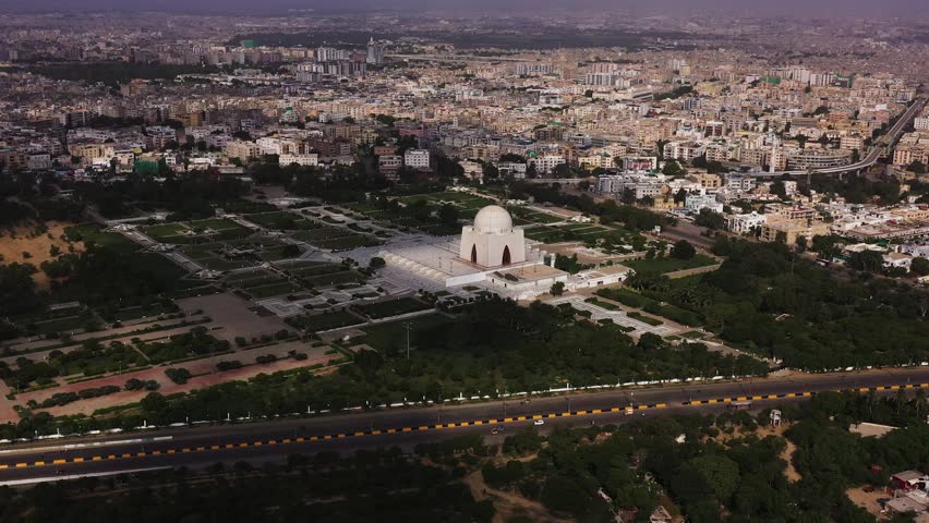 Drone view of Mazar-e-Quaid, Jinnah’s mausoleum, surrounded by lush gardens and Karachi’s cityscape. A national monument blending heritage, architecture, and urban contrast.