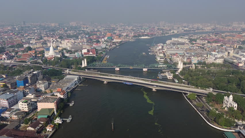 Aerial view of bridge and Wat Prayurawongsawas Warawihan pagoda, Bangkok, Thailand, 4k