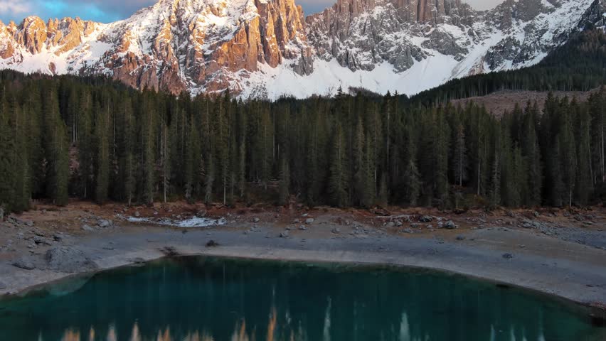 Flying up over lake, mountain and forest, Lago di Carezza, Dolomites, Italy, 4k