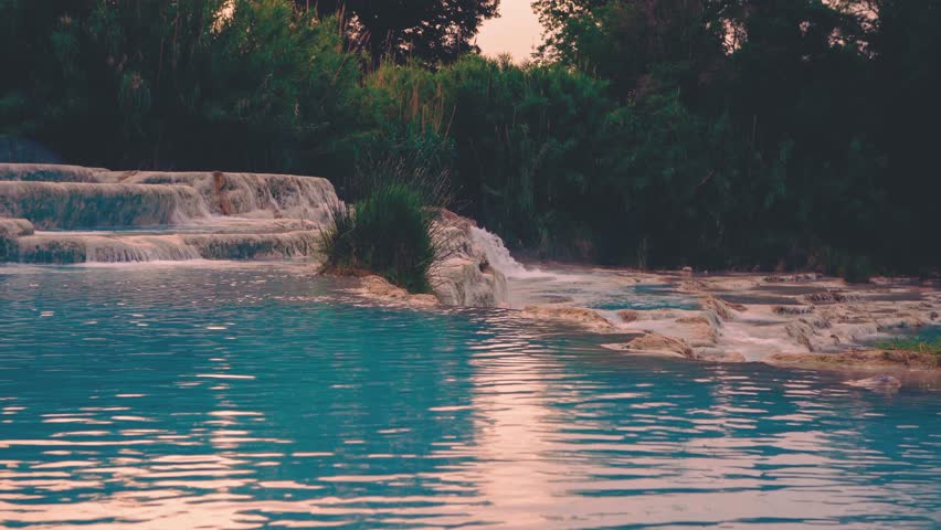 Cascate del Mulino hot springs at sunrise with steam rising and blue water flowing, cinemagraph