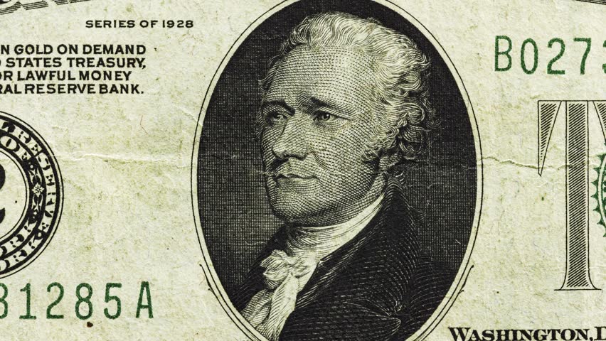Close pan of an old and worn U.S. ten dollar note showing oval portrait and aged paper texture
