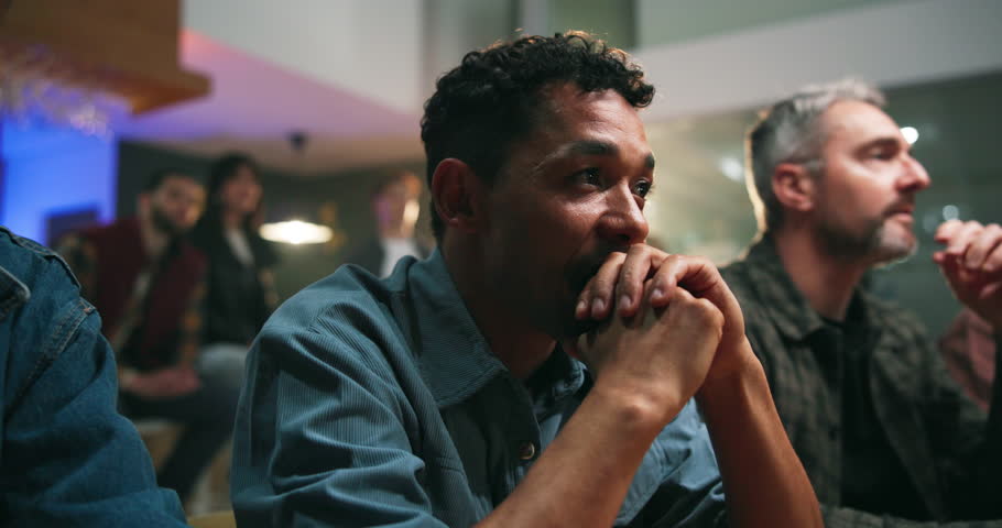 Victory, watching and people in home with bar, goal or celebration in soccer tournament. Support, sport and football fans in house with drink station, score lead and joint excitement in viewing party