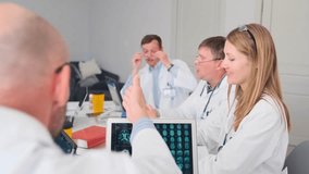 Medical team applauds and exchanges handshake after an inspiring lecture on brain biohacking. Professional doctors in lab coats show recognition and respect at the end of the seminar. - Powered by Shutterstock - Get 15% off with code: PIKWIZARD15