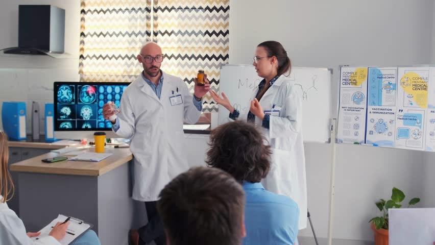 In a medical seminar, a pharmaceutical company representative promotes a new drug, but a female doctor takes the bottle and drops it to the floor, showing disapproval in front of colleagues.