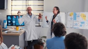 In a medical seminar, a pharmaceutical company representative promotes a new drug, but a female doctor takes the bottle and drops it to the floor, showing disapproval in front of colleagues. - Powered by Shutterstock - Get 15% off with code: PIKWIZARD15