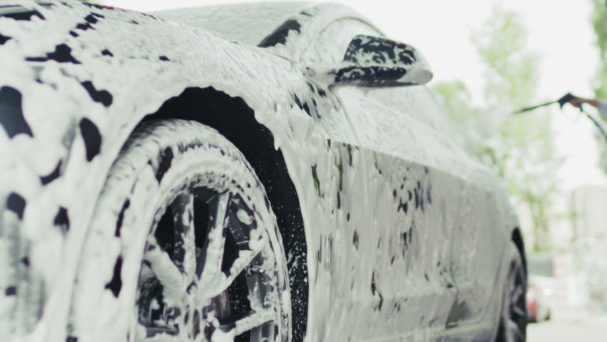 Woman Washing Her Car at Outdoor Car Wash