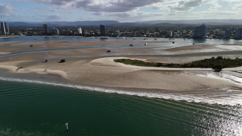 Curlew Island, Gold Coast, Queensland, Australia: 4K Aerial Drone Footage of Sandbanks, Tidal Flats, Mangroves, Boats and Coastal Landscape with City Skyline and Pacific Ocean