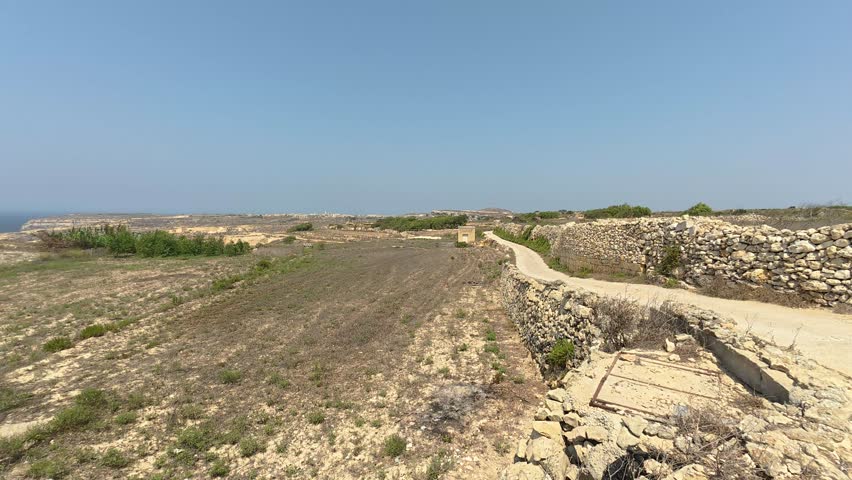 Fields near the sea on the Mediterranean island of Gozo in the Maltese archipelago. Summer 2025.