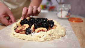 Preparing a Delicious Homemade Fruit Galette with Fresh Peaches and Mixed Berries for Dessert. - Powered by Shutterstock - Get 15% off with code: PIKWIZARD15