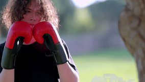 Boxer training with red gloves in a park - Powered by Shutterstock - Get 15% off with code: PIKWIZARD15