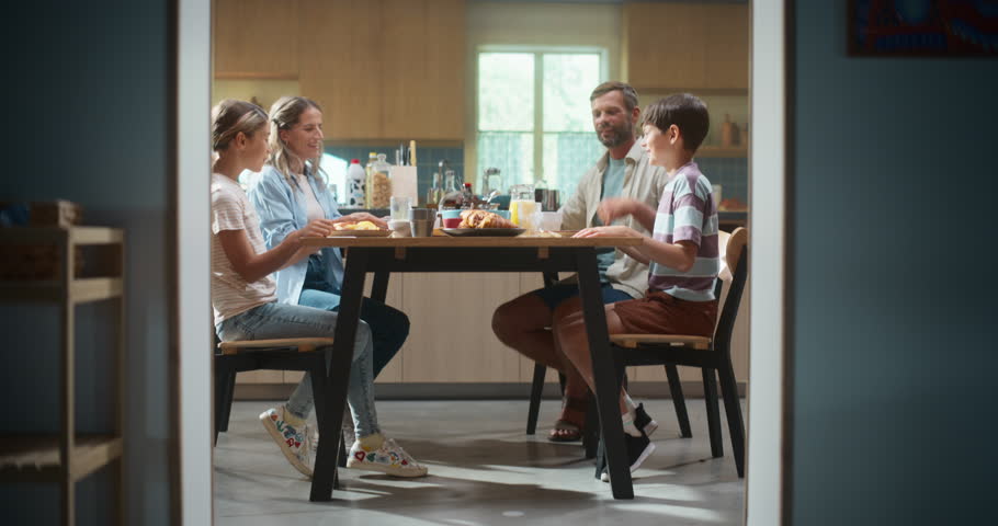 Parents and Children Gather in a Bright Kitchen, Enjoying Breakfast While Discussing School and Cooking Tips. Happy Energetic Parents and Children Have Healthy Meal and Daily Routine