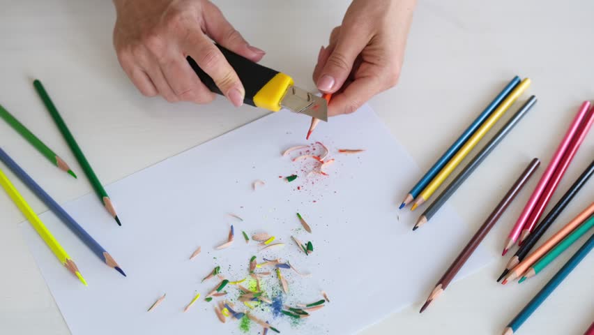 Close-Up View From Above Of A Woman Sharpening Pencils