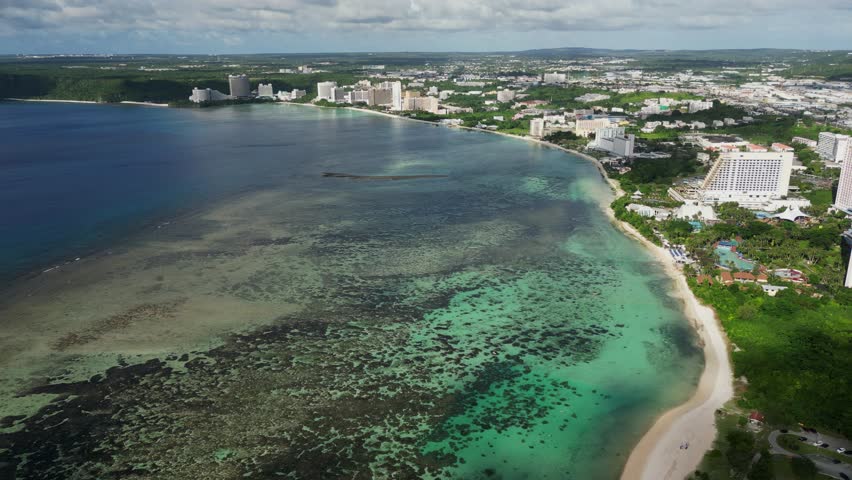 Aerial View Of Tumon Bay With Clear Turquoise Waters With Luxury Beachfront Hotels, Resort And Spa In Guam.