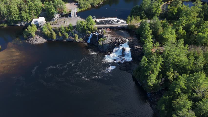 High Falls And The Muskoka River In Bracebridge, Ontario, Canada. Aerial Flyover Shot.