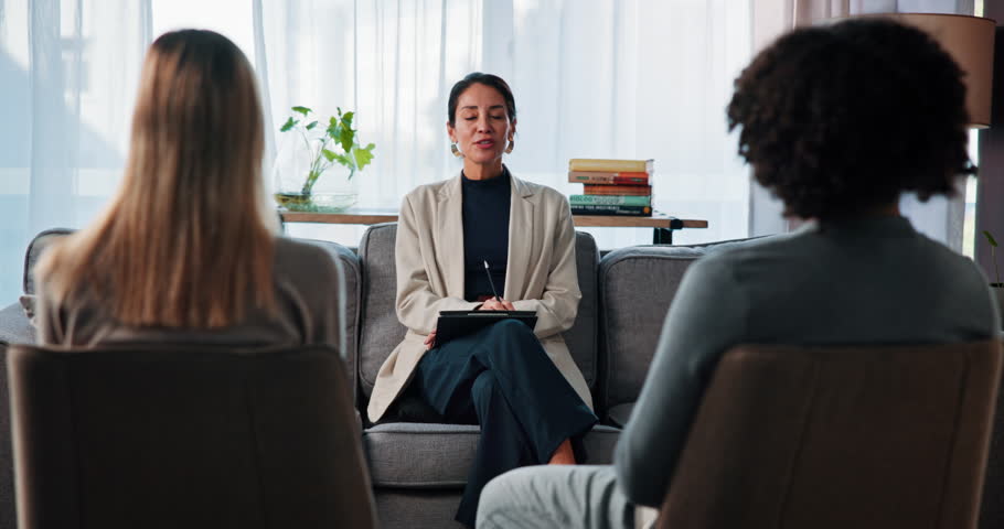 Sofa, couple and therapist with advice for counseling, marriage discussion and support for healing. Therapy, psychologist and woman with people in relationship, consultation and help with guidance