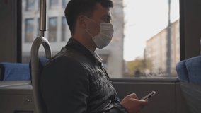 Sick man in medical mask sneezing on public transport in Europe, using smartphone. Protective face mask against virus and infection during commute. Pandemic prevention and hygiene concept. - Powered by Shutterstock - Get 15% off with code: PIKWIZARD15