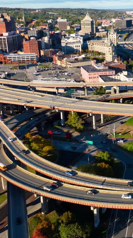 Multilevel highway interchange with bridges and overpasses in Albany, New York. Aerial top view of interstate 787 highway with cars. Vertical video.