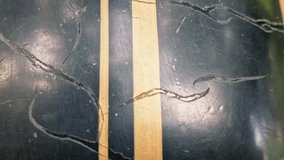 Black metal surface with a striking gold stripe, covered in numerous scrapes and scratches, creating a rugged, textured, and worn aesthetic. - Powered by Shutterstock - Get 15% off with code: PIKWIZARD15