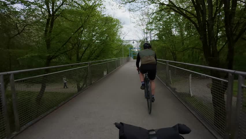 Perspective of a gravel or road bike rider cycling along safe suburban bike paths through quiet neighborhoods, highlighting everyday eco friendly transport and cycling lifestyle in Germany.