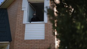 Girl thief wearing black mask carefully observes surroundings with binoculars from open window, checking for danger before escape. - Powered by Shutterstock - Get 15% off with code: PIKWIZARD15