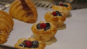 Array of delights including croissants and fruit flans topped with vibrant berries. Close up of bakery tray with fresh pastries. - Powered by Shutterstock - Get 15% off with code: PIKWIZARD15
