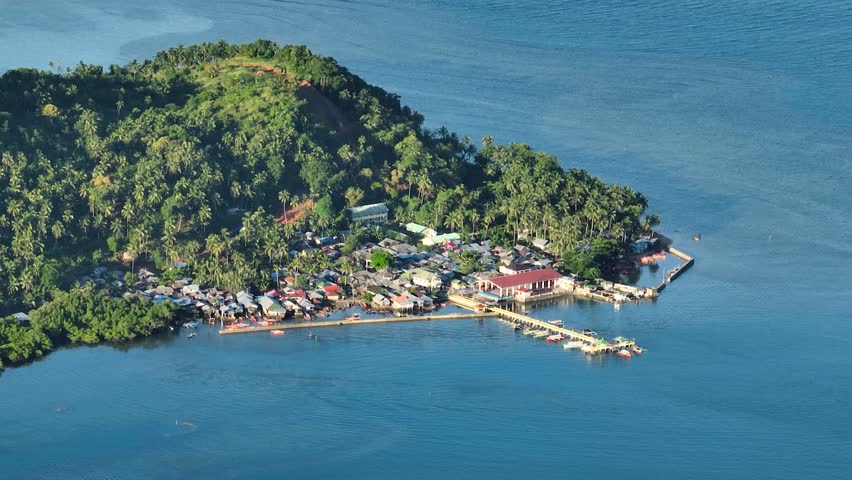 Stilt houses and blue sea in tropical island. Mindanao, Philippines. Zoom view.