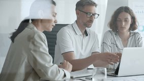 Business team collaborating and analyzing data on a laptop during a productive office meeting, discussing strategies and making informed decisions - Powered by Shutterstock - Get 15% off with code: PIKWIZARD15