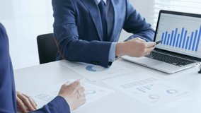Business team of several colleagues discussing financial data on a laptop while analyzing charts and market trends in office. Businesspeople and finance concept - Powered by Shutterstock - Get 15% off with code: PIKWIZARD15
