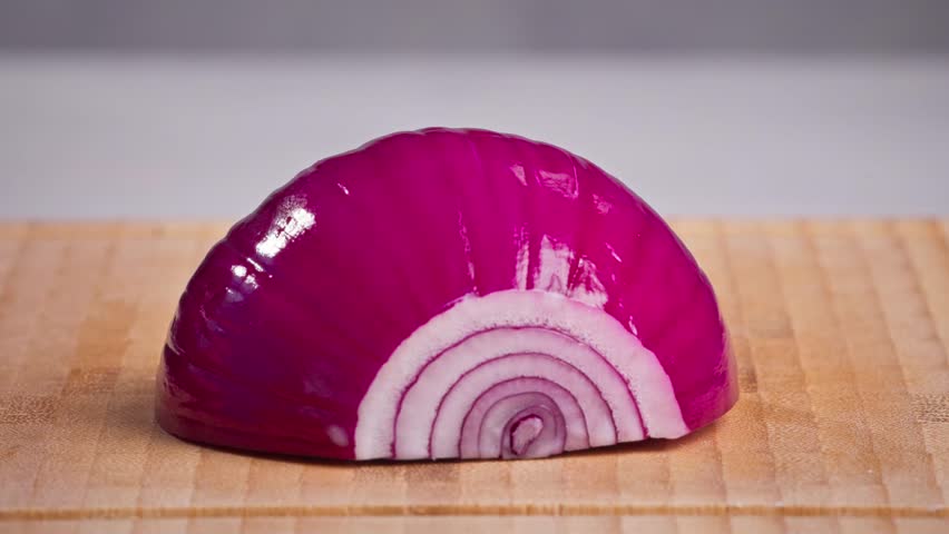chef cut onion on cutting board with sharp knife for making healthy meal and cooking, cook cutting red juicy onions for making salad, food closeup in kitchen