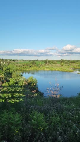 Nature Landscape Featuring Watery Reflections, Grassy Fields, And A Cloudy Blue Sky