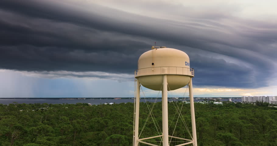 Florida summer storm over Charlotte Harbor water tower. Dark skies, heavy rain and humid tropical atmosphere.