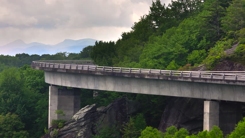Linn Cove Viaduct on Blue Ridge Parkway in summer rainy season. Mountain pass bridge in North Carolina Appalachian mountains, USA.