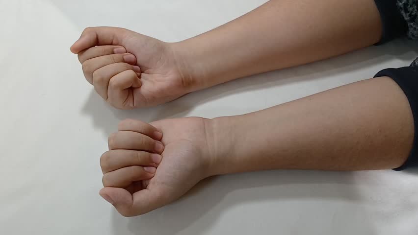 Concept footage of nickel and dime being held by left and right hands. The nickel, dime and the female hands are being shown in the clip.