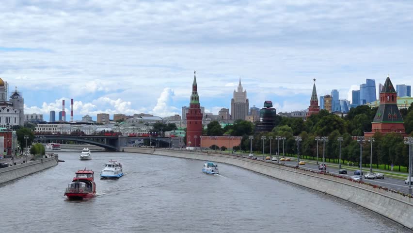 Panoramic view of Moscow city center and Moskva river with tour boat. The Red Square, Kremlin towers on background. Urban life travel. 