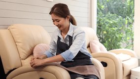 Asian beauty therapist wearing apron seated folding towel preparing for clients in spa salon shop, single woman small business entrepreneur startup pedicure nail shop, beauty treatment lifestyle owner - Powered by Shutterstock - Get 15% off with code: PIKWIZARD15